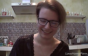 Solo girl with glasses chatting in the kitchen