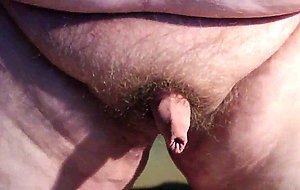Fat boys tiny penis being pushed around while standing up.