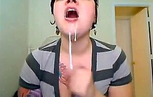 big titted, tattooed babe throatfucks herself