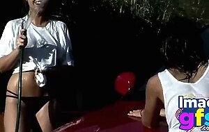 Two Hot Brunette Naked Carwash showing big medium tits and perfect ass