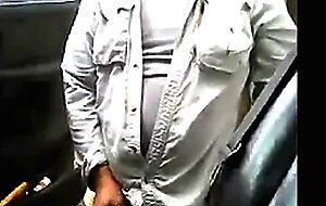 Bearded daddy strokes his cock by his truck outdoors.