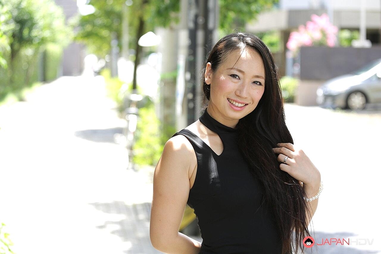 Japanese beauty Aya Shiina models on a city street in a black dress